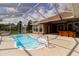Inviting pool with a screened lanai featuring a bar and ample space for outdoor enjoyment at 9093 S Bay Dr, Haines City, FL 33844