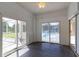 Enclosed sun room with tile flooring and sliding glass doors that offer pool views at 9093 S Bay Dr, Haines City, FL 33844