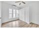 Bedroom featuring a ceiling fan, multiple windows, wood-look flooring, and a closet at 911 S Missouri Ave, Lakeland, FL 33803