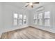 Bright bedroom with multiple windows, a ceiling fan, and wood-look flooring at 911 S Missouri Ave, Lakeland, FL 33803