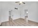 Bedroom featuring wood-look flooring, a ceiling fan, and open doorways at 911 S Missouri Ave, Lakeland, FL 33803