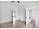 Bedroom with wood-look flooring, multiple windows, and an adjoining bathroom at 911 S Missouri Ave, Lakeland, FL 33803