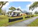 Exterior view of a bungalow featuring a well-manicured lawn, dark trim and inviting front porch at 911 S Missouri Ave, Lakeland, FL 33803