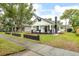 Exterior view of a well-maintained home with a cozy front porch and manicured lawn at 911 S Missouri Ave, Lakeland, FL 33803