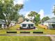 Charming bungalow with a cozy front porch, dark trim, and a meticulously landscaped front yard at 911 S Missouri Ave, Lakeland, FL 33803