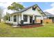 Charming bungalow with a cozy front porch, contrasting trim, and well-maintained landscaping at 911 S Missouri Ave, Lakeland, FL 33803