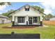 Charming bungalow with black and white trim, inviting front porch and well-maintained front yard at 911 S Missouri Ave, Lakeland, FL 33803