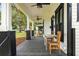 Inviting front porch with a fan, comfortable seating area, and stylish design elements at 911 S Missouri Ave, Lakeland, FL 33803
