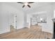 Spacious living room with new flooring, paint and view into kitchen at 911 S Missouri Ave, Lakeland, FL 33803