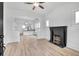 Bright living room with a fireplace and an open view of the eat-in kitchen at 911 S Missouri Ave, Lakeland, FL 33803