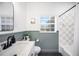 Bathroom with vanity, shower and tub with unique tile design and black hardware at 916 Woodward St, Lakeland, FL 33803