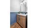 Bathroom boasting single sink vanity, modern finishes and blue color accents at 916 Woodward St, Lakeland, FL 33803