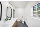 Stylish bathroom features double sinks, white counters, and modern fixtures at 916 Woodward St, Lakeland, FL 33803