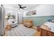 Bright Bedroom with hardwood floors, green wainscotting, crib, rocking chair, and animal-themed decorations at 916 Woodward St, Lakeland, FL 33803