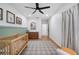 Bedroom features crib, dresser, hardwood floors, area rug, and animal-themed artwork at 916 Woodward St, Lakeland, FL 33803