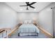 Bright bedroom with a ceiling fan, neutral walls and decor, and hardwood floors provides a relaxing space at 916 Woodward St, Lakeland, FL 33803