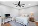 Bedroom with hardwood floors, ceiling fan, desk, and light-colored furnishings at 916 Woodward St, Lakeland, FL 33803