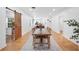 Elegant dining room with a long wooden table, hardwood floors and a barn door at 916 Woodward St, Lakeland, FL 33803