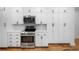 Updated kitchen features stainless steel appliances and modern white cabinetry at 916 Woodward St, Lakeland, FL 33803