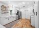Modern kitchen with white cabinets, stainless steel appliances, and hardwood floors at 916 Woodward St, Lakeland, FL 33803