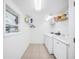 Well-lit laundry room with modern washer, dryer, and ample storage for efficient household tasks at 916 Woodward St, Lakeland, FL 33803