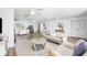 Expansive living room merging kitchen and dining areas, bathed in natural light creating a warm, inviting ambiance at 916 Woodward St, Lakeland, FL 33803
