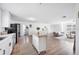 Open concept living room and kitchen featuring stainless steel appliances and modern furnishings at 916 Woodward St, Lakeland, FL 33803