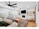 Comfortable living room features a stone fireplace, wood floors and modern decor at 916 Woodward St, Lakeland, FL 33803