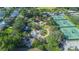 Aerial of a colorful playground and tennis courts surrounded by trees at 916 Woodward St, Lakeland, FL 33803