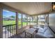 Relaxing screened porch with comfortable seating and a pleasant view of the neighborhood at 916 Woodward St, Lakeland, FL 33803