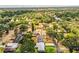 An aerial view shows this home nestled in a neighborhood surrounded by lush green trees at 960 Lila St, Bartow, FL 33830