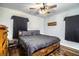 Comfortable bedroom featuring a modern bed frame, wood-look flooring, and a ceiling fan for added comfort at 960 Lila St, Bartow, FL 33830