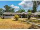 Charming single-story home with a carport and front yard featuring palm trees at 960 Lila St, Bartow, FL 33830