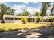 Well-maintained one-story home featuring black shutters, palm trees and covered parking at 960 Lila St, Bartow, FL 33830