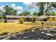 Charming single-story home with a carport and front yard featuring palm trees at 960 Lila St, Bartow, FL 33830