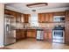 Well-equipped kitchen with stainless steel appliances, wood cabinets, and tile flooring for easy maintenance at 960 Lila St, Bartow, FL 33830