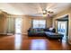 Inviting living room with hardwood floors, a modern sectional sofa, and large window with bright natural light at 960 Lila St, Bartow, FL 33830