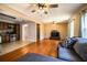 Open-concept layout showcasing the spacious living room with hardwood floors, seamlessly connected to the modern kitchen at 960 Lila St, Bartow, FL 33830