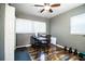 Versatile home office space featuring wood-look flooring, ample natural light, and space for exercise equipment at 960 Lila St, Bartow, FL 33830