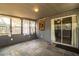 Enclosed sunroom with stone flooring, multiple windows for natural light, and backyard access for seamless indoor-outdoor living at 960 Lila St, Bartow, FL 33830