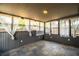 Relaxing sunroom filled with natural light, featuring slate floors and sheer curtains for privacy and enjoyment at 960 Lila St, Bartow, FL 33830