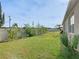 Spacious fenced backyard features a well-maintained lawn and mature trees at 120 Grove Branch Rd, Winter Haven, FL 33880