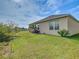 Lush green backyard with well-manicured lawn and shrubbery offers space for outdoor living at 120 Grove Branch Rd, Winter Haven, FL 33880