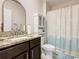 Bathroom with granite counters, neutral walls, updated mirror, and shower/tub combo at 120 Grove Branch Rd, Winter Haven, FL 33880