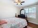 Bedroom features a wooden bed frame, flamingo themed bedspread, and hardwood floors at 120 Grove Branch Rd, Winter Haven, FL 33880