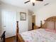Bedroom features a wooden bed frame, flamingo themed bedspread, and hardwood floors at 120 Grove Branch Rd, Winter Haven, FL 33880