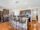 Modern kitchen with granite island, dark cabinets, stainless appliances and bar stool seating at 120 Grove Branch Rd, Winter Haven, FL 33880
