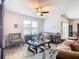 Comfortable living room with a plush sofa, wooden accents, and large windows at 120 Grove Branch Rd, Winter Haven, FL 33880