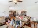Open-concept living room flowing into the kitchen with hardwood floors and cozy furniture at 120 Grove Branch Rd, Winter Haven, FL 33880