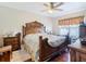 Main bedroom with a decorative wooden bed frame, ceiling fan, and hardwood floors at 120 Grove Branch Rd, Winter Haven, FL 33880